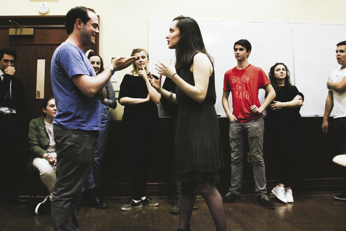 Woman and man speaking to each other in an improv class